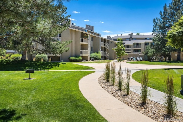 view of property's community with a lawn