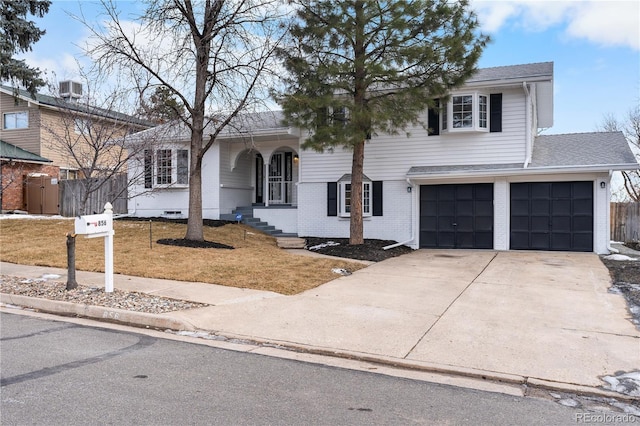 view of front of home with a front yard, a garage, and cooling unit