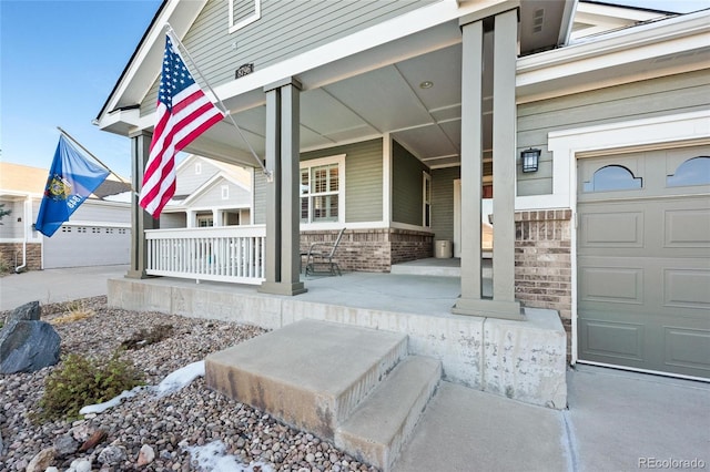 entrance to property featuring a porch and a garage