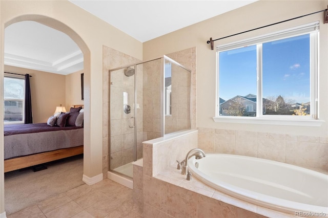 bathroom with tile patterned floors, plenty of natural light, and plus walk in shower