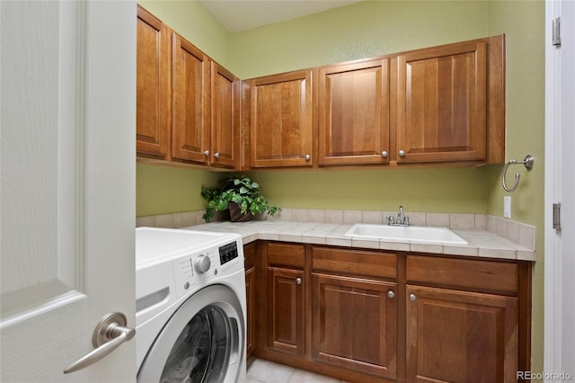 laundry room featuring sink, washer / clothes dryer, and cabinets