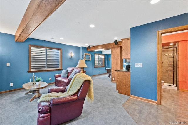 living room featuring light carpet and beamed ceiling