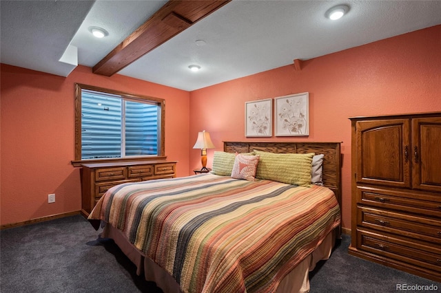 carpeted bedroom with vaulted ceiling with beams