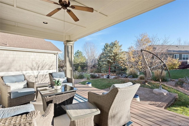 exterior space with an outdoor living space, ceiling fan, and a wooden deck