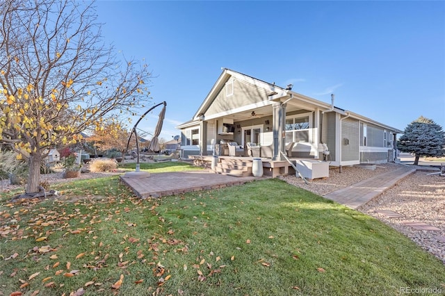 rear view of house with a patio area and a yard