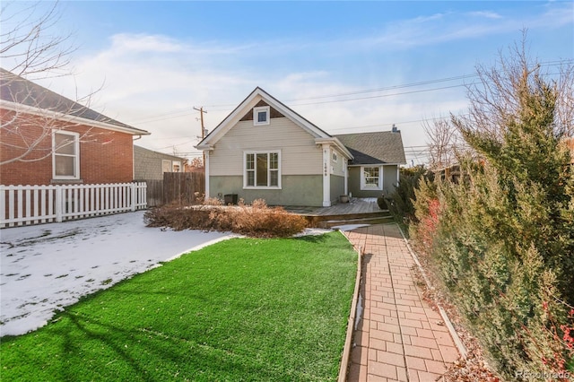 exterior space with a front yard and central AC unit