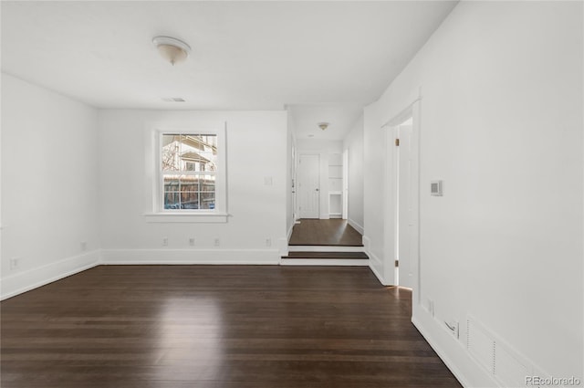 spare room with dark hardwood / wood-style flooring