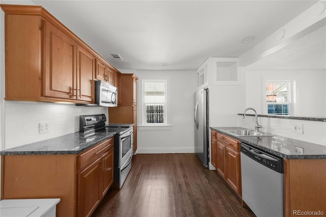 kitchen featuring plenty of natural light, sink, stainless steel appliances, and dark wood-type flooring