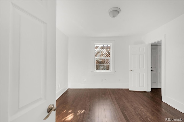 empty room with dark wood-type flooring