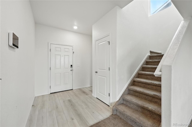 9723 Borderpine Way, Colorado Springs, CO 80925 - foyer entrance featuring stairway, light wood-style flooring, and recessed lighting