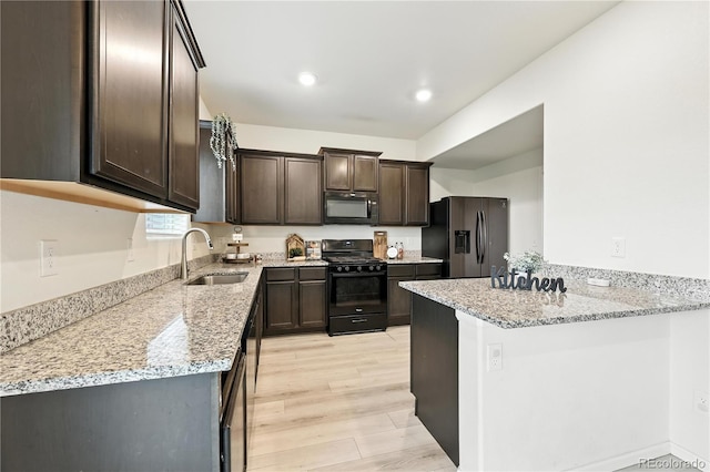 9723 Borderpine Way, Colorado Springs, CO 80925 - kitchen featuring black appliances, dark brown cabinetry, light stone countertops, a peninsula, and light wood-style floors