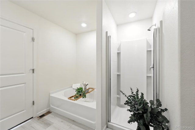 9723 Borderpine Way, Colorado Springs, CO 80925 - bathroom featuring a garden tub, a stall shower, and recessed lighting
