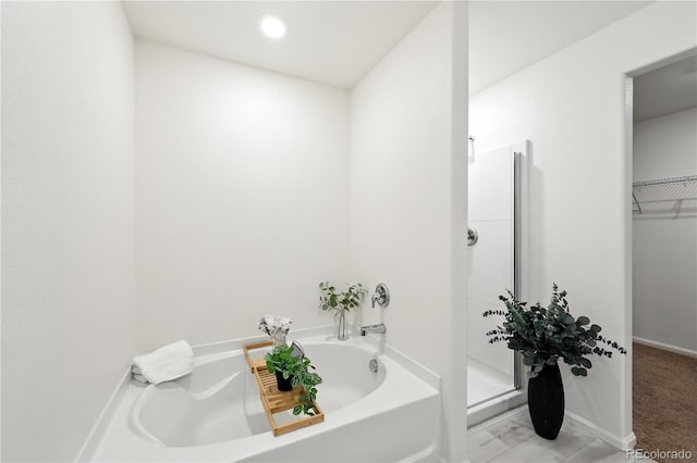 9723 Borderpine Way, Colorado Springs, CO 80925 - full bath with a garden tub, a stall shower, and a walk in closet
