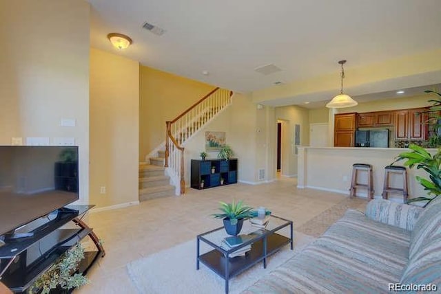10451 Truckee St Unit 2D, Commerce City, CO 80022 - living room featuring stairs and baseboards