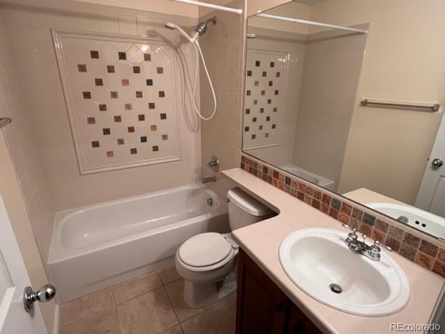 10451 Truckee St Unit 2D, Commerce City, CO 80022 - bathroom with shower / tub combination, toilet, vanity, and tile patterned flooring