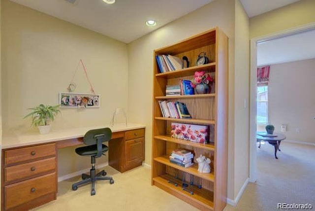 10451 Truckee St Unit 2D, Commerce City, CO 80022 - home office featuring light carpet, baseboards, and built in desk