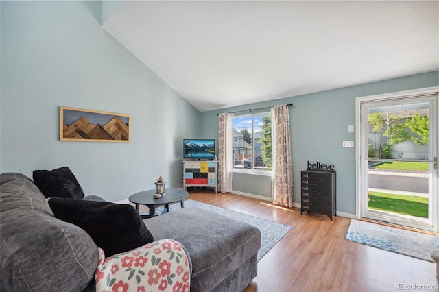7977 Emerson Ave, Frederick, CO 80530 - living area featuring wood finished floors and lofted ceiling