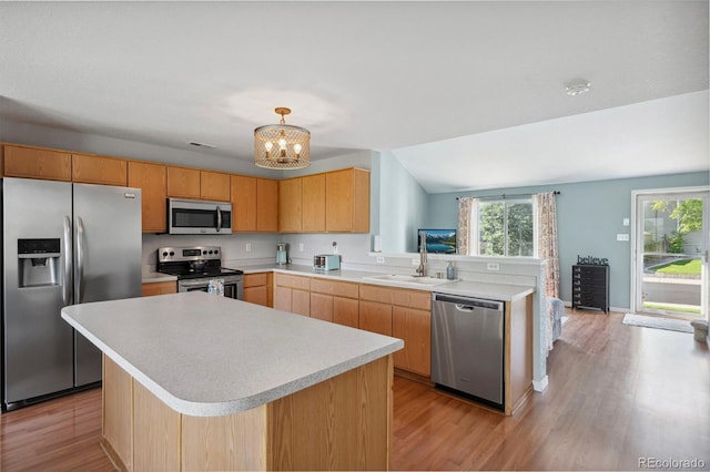 7977 Emerson Ave, Frederick, CO 80530 - kitchen featuring appliances with stainless steel finishes, light countertops, healthy amount of natural light, a chandelier, and vaulted ceiling