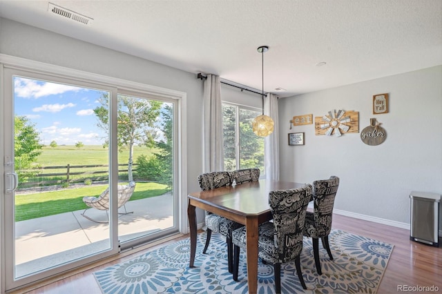 7977 Emerson Ave, Frederick, CO 80530 - dining area with wood finished floors and a textured ceiling