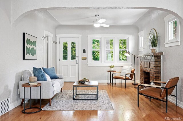 3321 Stuart St, Denver, CO 80212 - living room featuring ceiling fan, healthy amount of natural light, wood-type flooring, a textured wall, and arched walkways