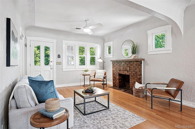 3321 Stuart St, Denver, CO 80212 - living room featuring plenty of natural light, ceiling fan, a fireplace, wood finished floors, and a textured wall