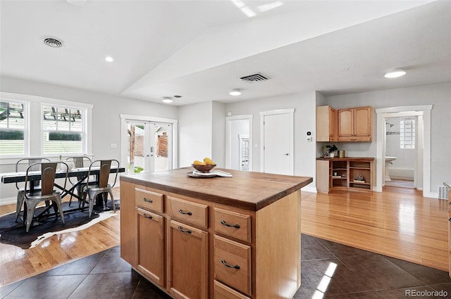 3321 Stuart St, Denver, CO 80212 - kitchen featuring dark tile patterned flooring, butcher block countertops, french doors, vaulted ceiling, and plenty of natural light