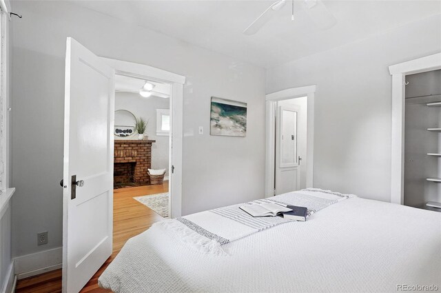3321 Stuart St, Denver, CO 80212 - bedroom featuring wood finished floors, a brick fireplace, and a ceiling fan