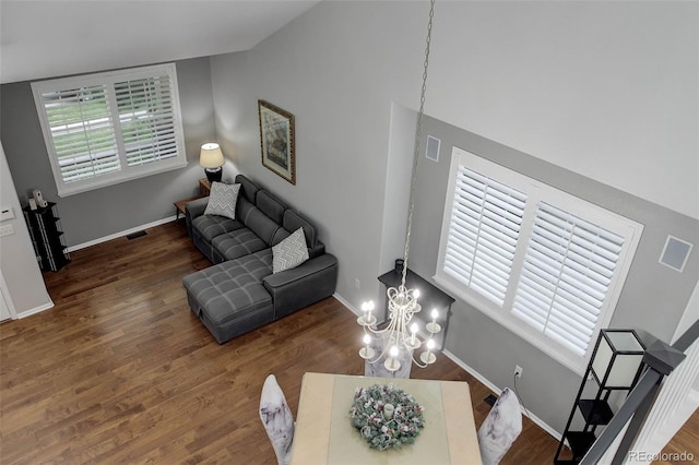 15372 E 117th Ave, Commerce City, CO 80022 - living area with wood finished floors, a chandelier, and baseboards