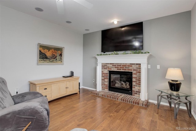15372 E 117th Ave, Commerce City, CO 80022 - living room with wood finished floors, ceiling fan, a fireplace, and baseboards
