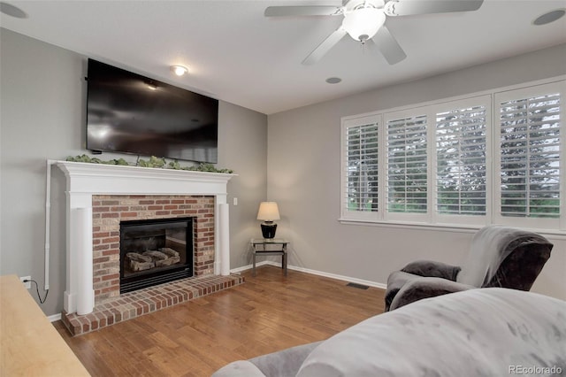 15372 E 117th Ave, Commerce City, CO 80022 - living room featuring baseboards, wood finished floors, a fireplace, and ceiling fan