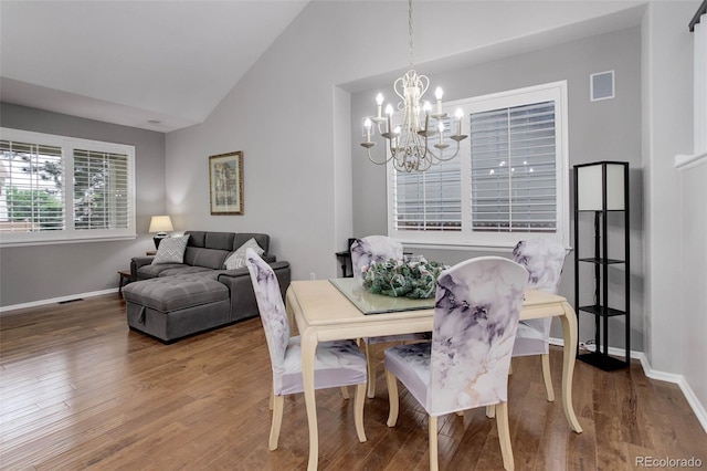 15372 E 117th Ave, Commerce City, CO 80022 - dining space featuring a chandelier, wood finished floors, baseboards, and high vaulted ceiling