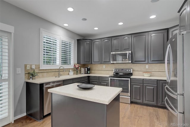 15372 E 117th Ave, Commerce City, CO 80022 - kitchen with appliances with stainless steel finishes, a sink, decorative backsplash, recessed lighting, and light wood-style floors