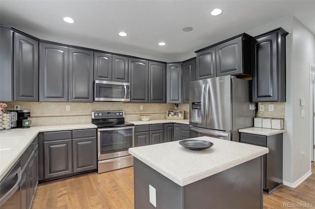 15372 E 117th Ave, Commerce City, CO 80022 - kitchen with stainless steel appliances, light wood-style floors, decorative backsplash, light countertops, and recessed lighting