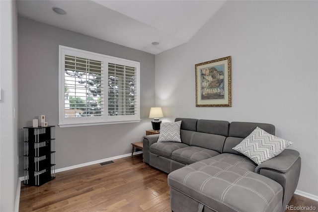 15372 E 117th Ave, Commerce City, CO 80022 - living room featuring wood finished floors, baseboards, and lofted ceiling