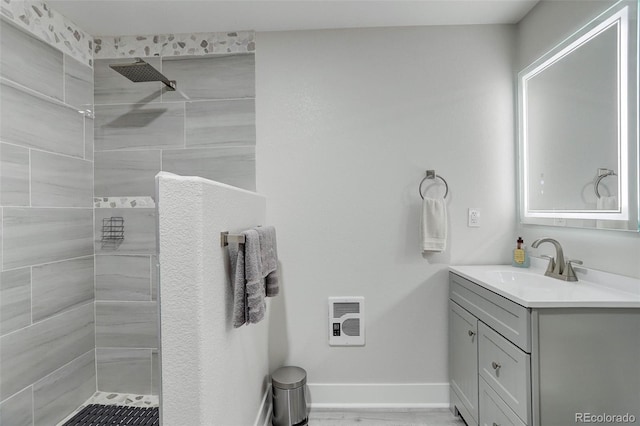 15372 E 117th Ave, Commerce City, CO 80022 - bathroom featuring vanity, tiled shower, heating unit, and baseboards