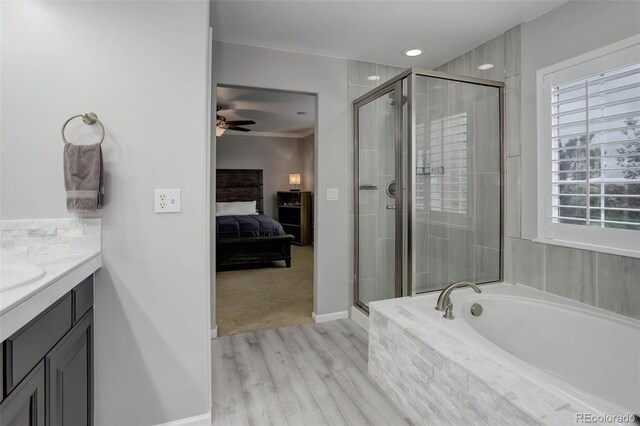15372 E 117th Ave, Commerce City, CO 80022 - full bathroom featuring a shower stall, ensuite bath, a bath, wood finished floors, and vanity