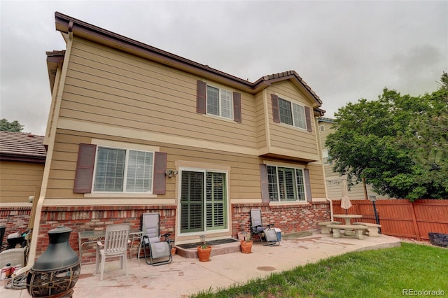 15372 E 117th Ave, Commerce City, CO 80022 - rear view of property with a patio area and brick siding
