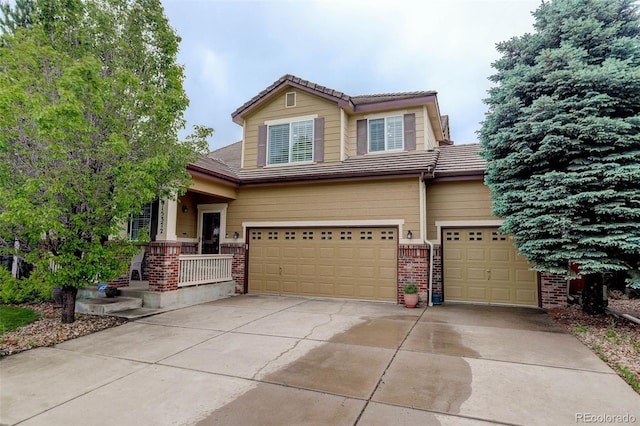 15372 E 117th Ave, Commerce City, CO 80022 - view of front of house with brick siding, an attached garage, a tile roof, and concrete driveway