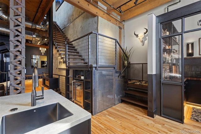 interior space featuring sink, wood-type flooring, and rail lighting