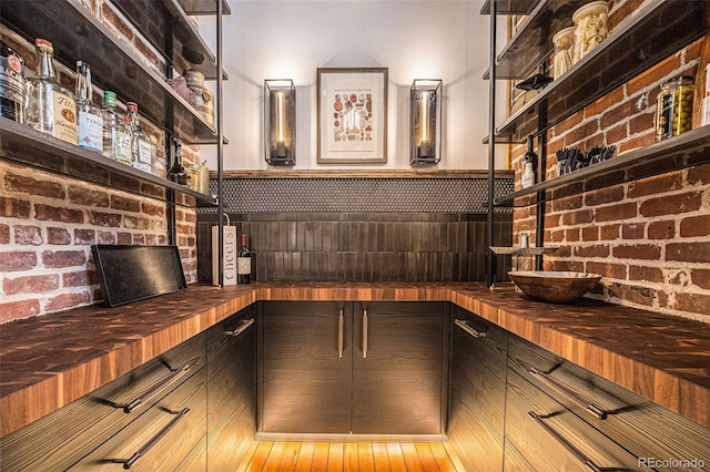 kitchen with brick wall and butcher block counters