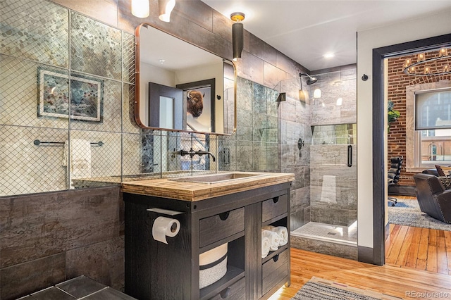 bathroom featuring vanity, a shower with door, and hardwood / wood-style floors