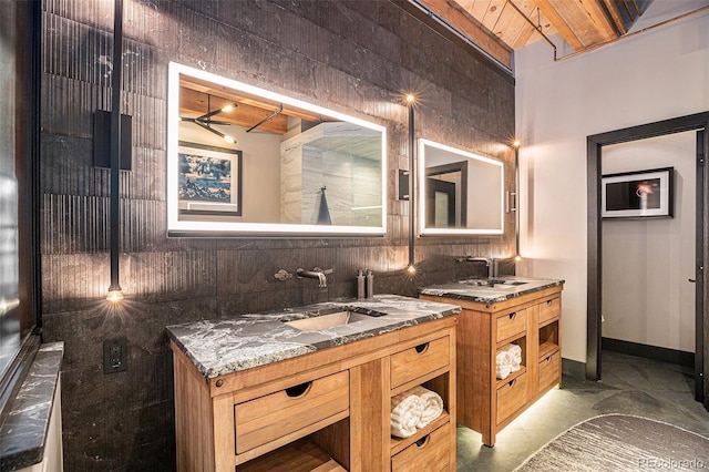 bathroom featuring tile walls, vanity, beam ceiling, and wooden ceiling