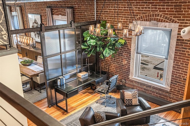 interior space featuring brick wall and hardwood / wood-style floors