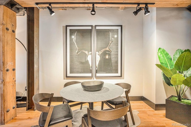 dining area featuring track lighting and light wood-type flooring