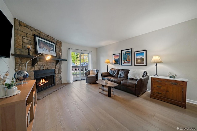 8335 Fairmount Dr Unit 2-105, Denver, CO 80247 - living room with light wood finished floors, a fireplace, and baseboards