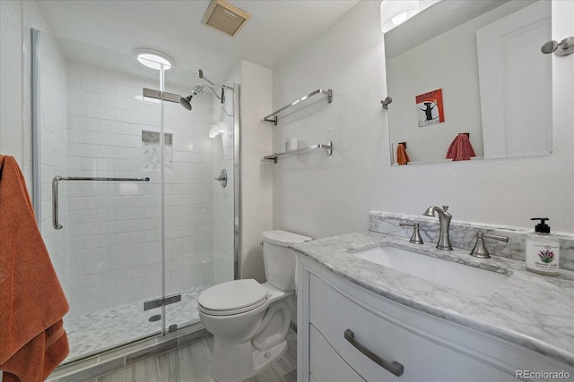 8335 Fairmount Dr Unit 2-105, Denver, CO 80247 - full bathroom featuring vanity, toilet, and a shower stall