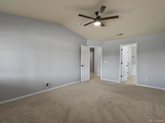7131 S Wenatchee Way Unit C, Aurora, CO 80016 - unfurnished bedroom featuring vaulted ceiling, light carpet, ensuite bathroom, and a ceiling fan