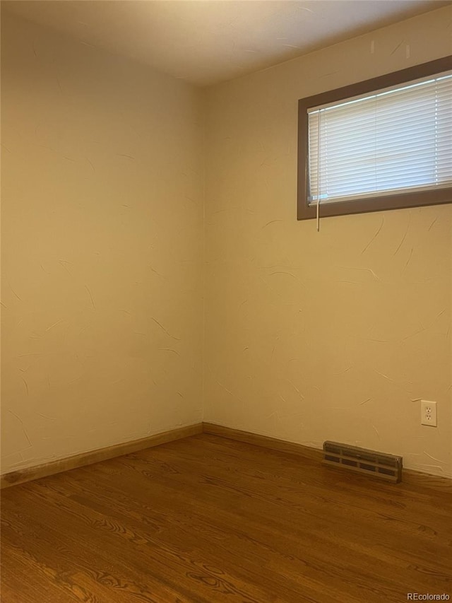 empty room with hardwood / wood-style floors