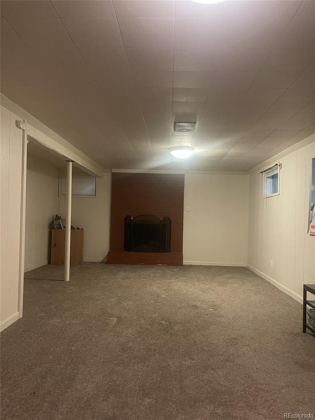 basement featuring carpet floors and a fireplace