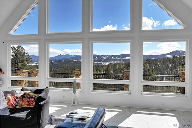 sunroom with a mountain view and lofted ceiling